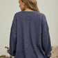 SPLIT NECK RAW EDGE LONG SLEEVE RIBBED KNIT TOP